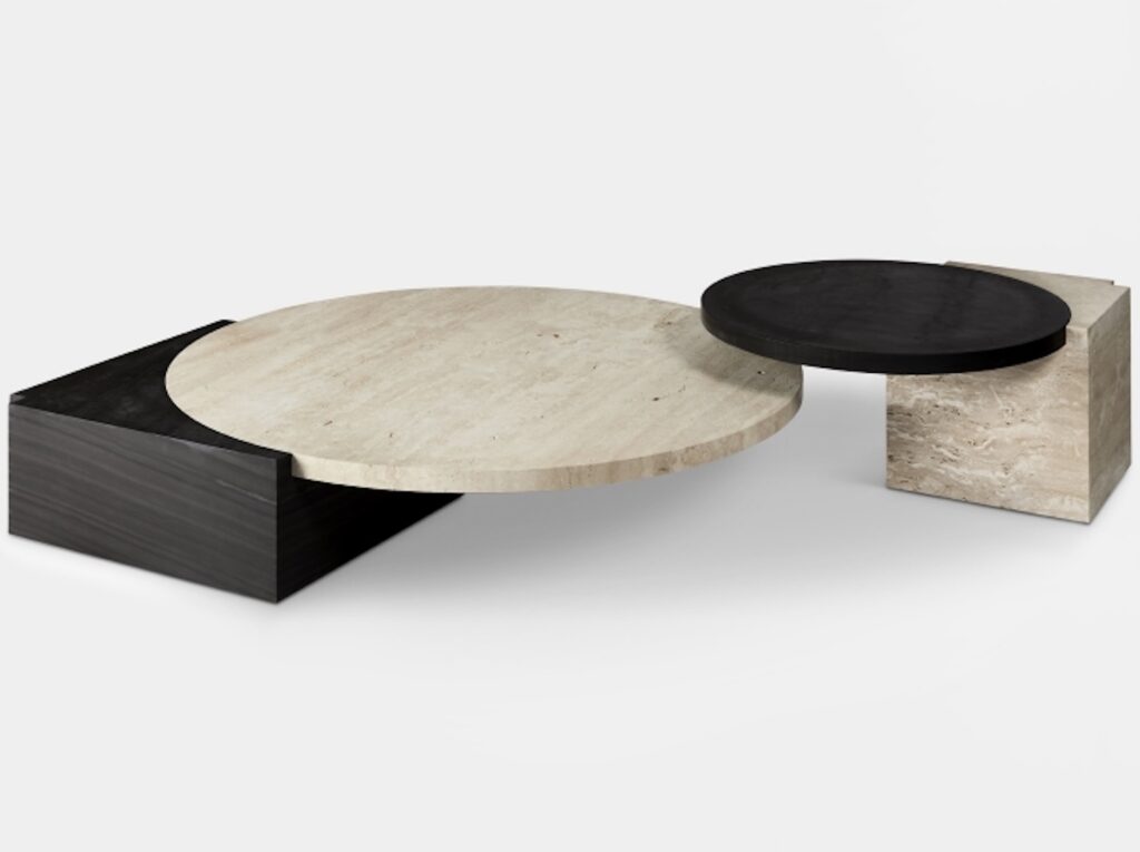 Two marble tables with rectangular pedestal bases and circular tabletops in contrasting white and black