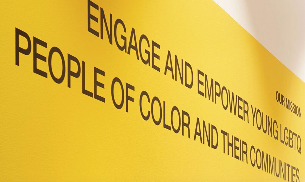 Close view of Rrach L.A. mission statement painted on yellow wall