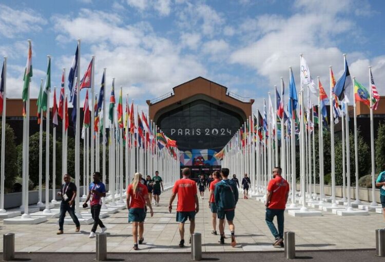 Olympic athletes at Olympic Village entrance