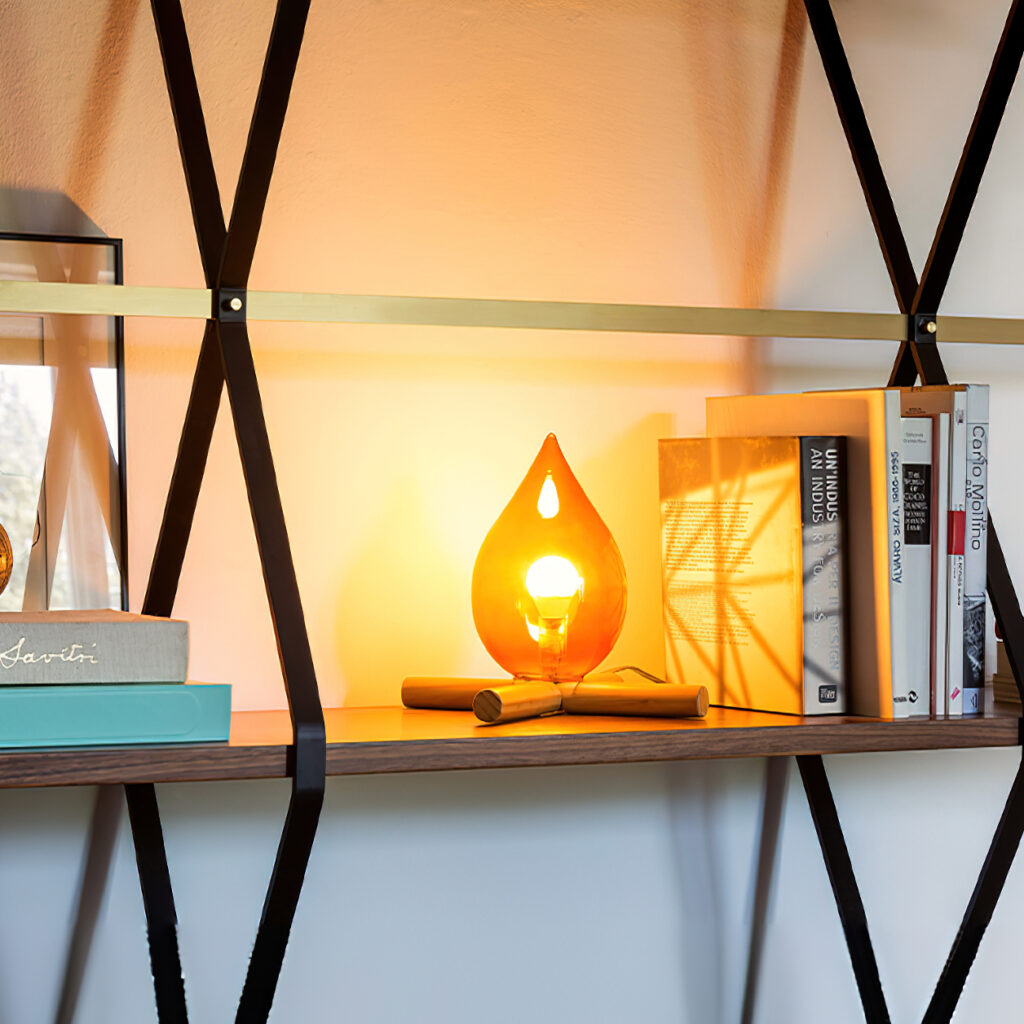 Campfire table lamp on shelf with books