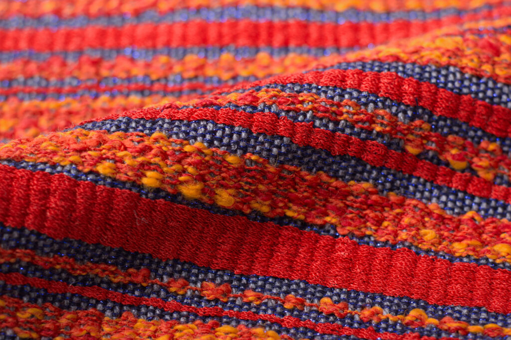 Fiery textile with solid orange stripe, yellow/orange stripe, and thin blue stripe