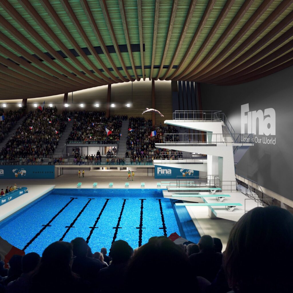 Same view as above but lit at night with spectators in stands and diver in mid-air