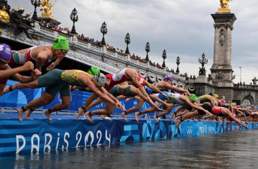 Triathletes diving into the Seine