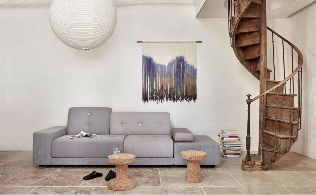 Stools in sitting area with spiral staircase and nice sofa