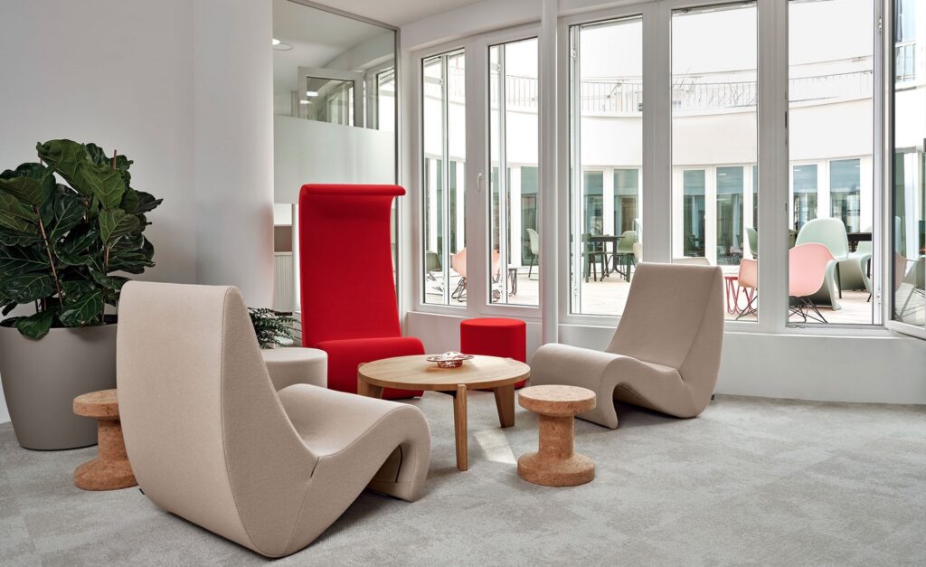 Two stools in sitting area with table and three outlandish chairs with high backs