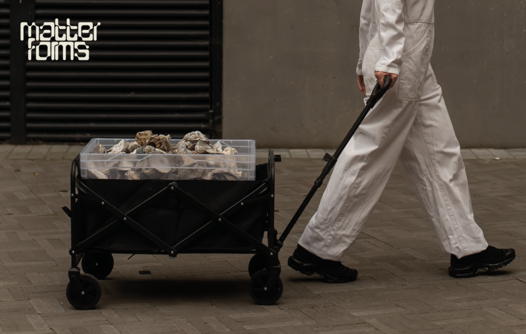 Matter Forms branding with a trolley full of oyster shells pulled by person wearing all white