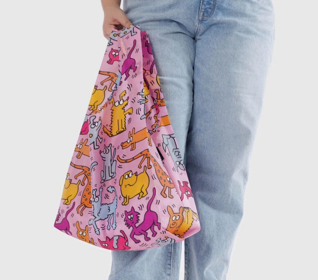 Keith Haring tote held by person in jeans