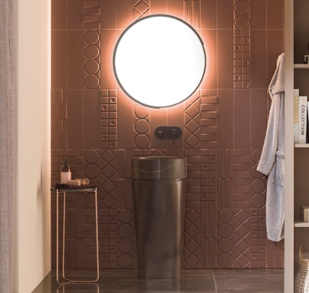 Geo in rust in bathroom with round illuminated mirror