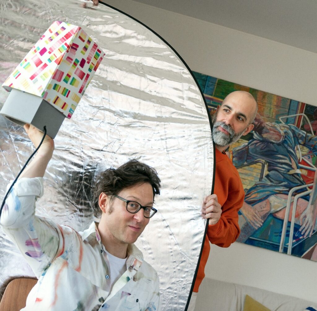 The designer holding up the lamp